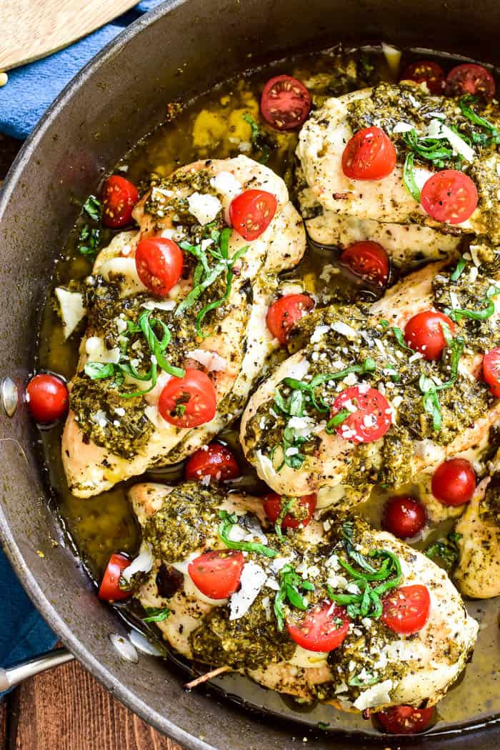This Cheesy Pesto Stuffed Chicken is the ultimate dinner recipe! Ready in 30 minute or less, this dish is packed with flavor and so easy to make. It combines boneless, skinless chicken breasts with basil pesto, grape tomatoes, and two types of cheese. Perfect for weekday dinners or date nights in....if you're looking for an easy, delicious twist on dinner, you'll love this stuffed chicken recipe!