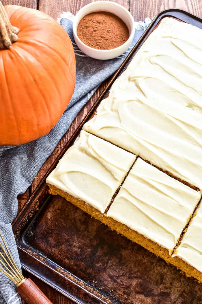 Pumpkin Sheet Cake is the ultimate taste of fall! Light, fluffy pumpkin cake topped with cream cheese frosting and a twist of maple syrup. This cake is easy to make and ideal for feeding a crowd. The perfect dessert for Thanksgiving or any fall gathering!