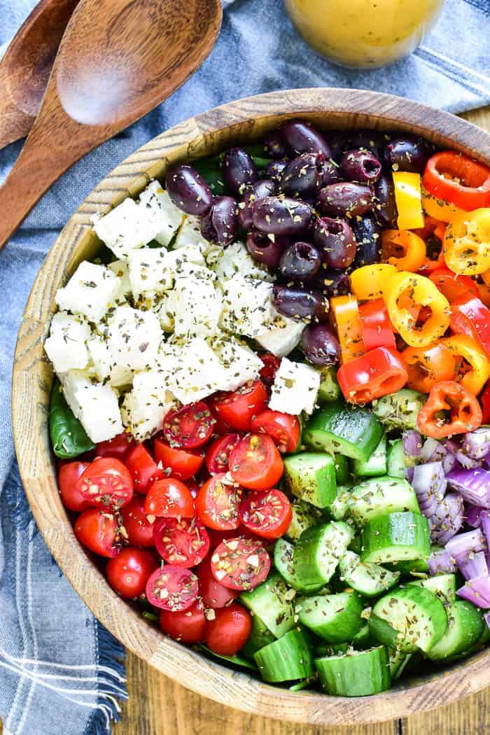 Greek Salad in serving bowl with wooden salad servers