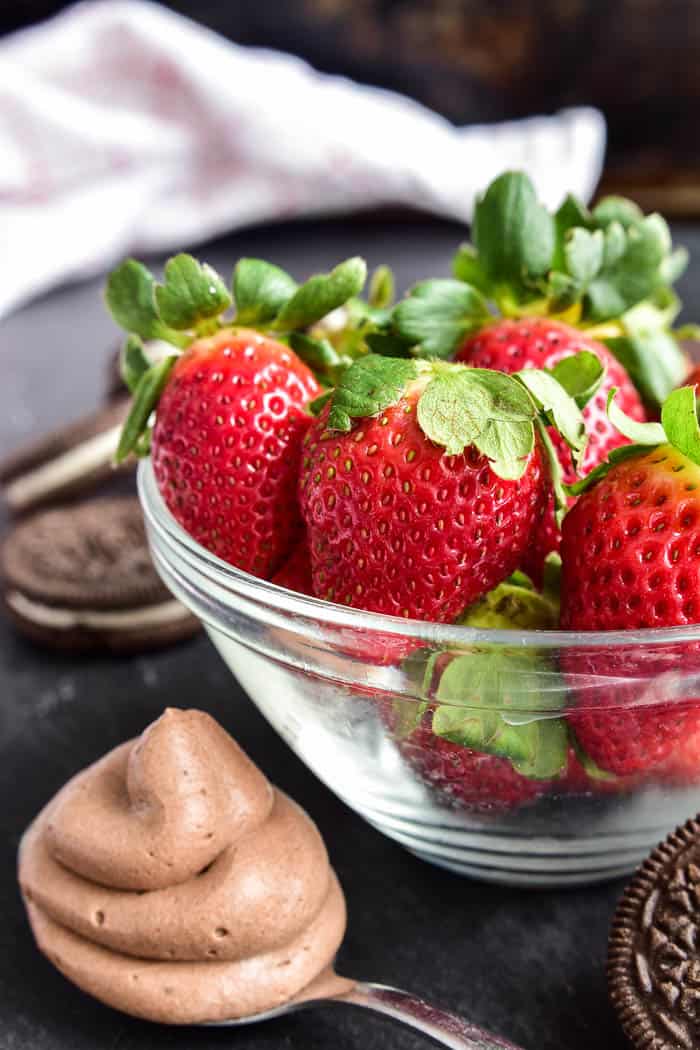 bowl of strawberries with spoonful of chocolate mousse