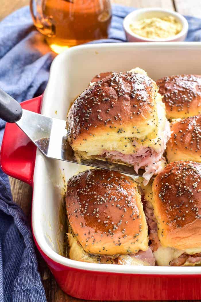 Honey Mustard Ham & Cheese Sliders in pan with serving spatula