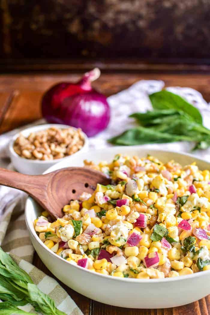 Fresh corn salad with serving spoon