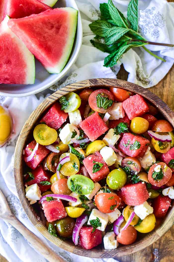 Watermelon Feta Salad with fresh ingredients in the background