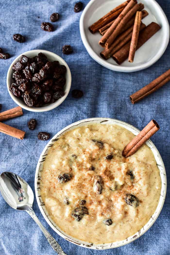 Rice Pudding in a dish with raisins and cinnamon sticks