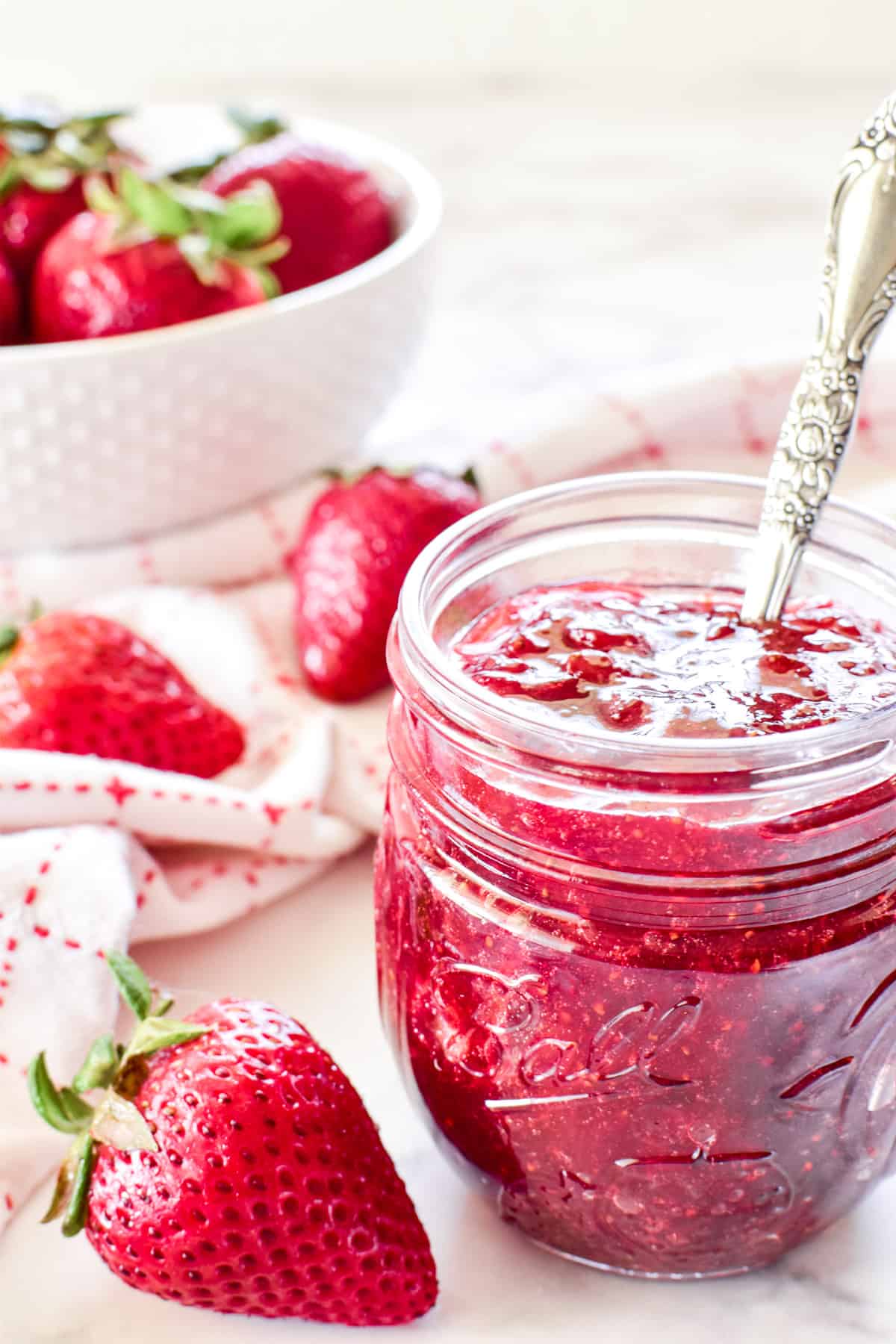 Strawberry Jam in a jar with a spoon